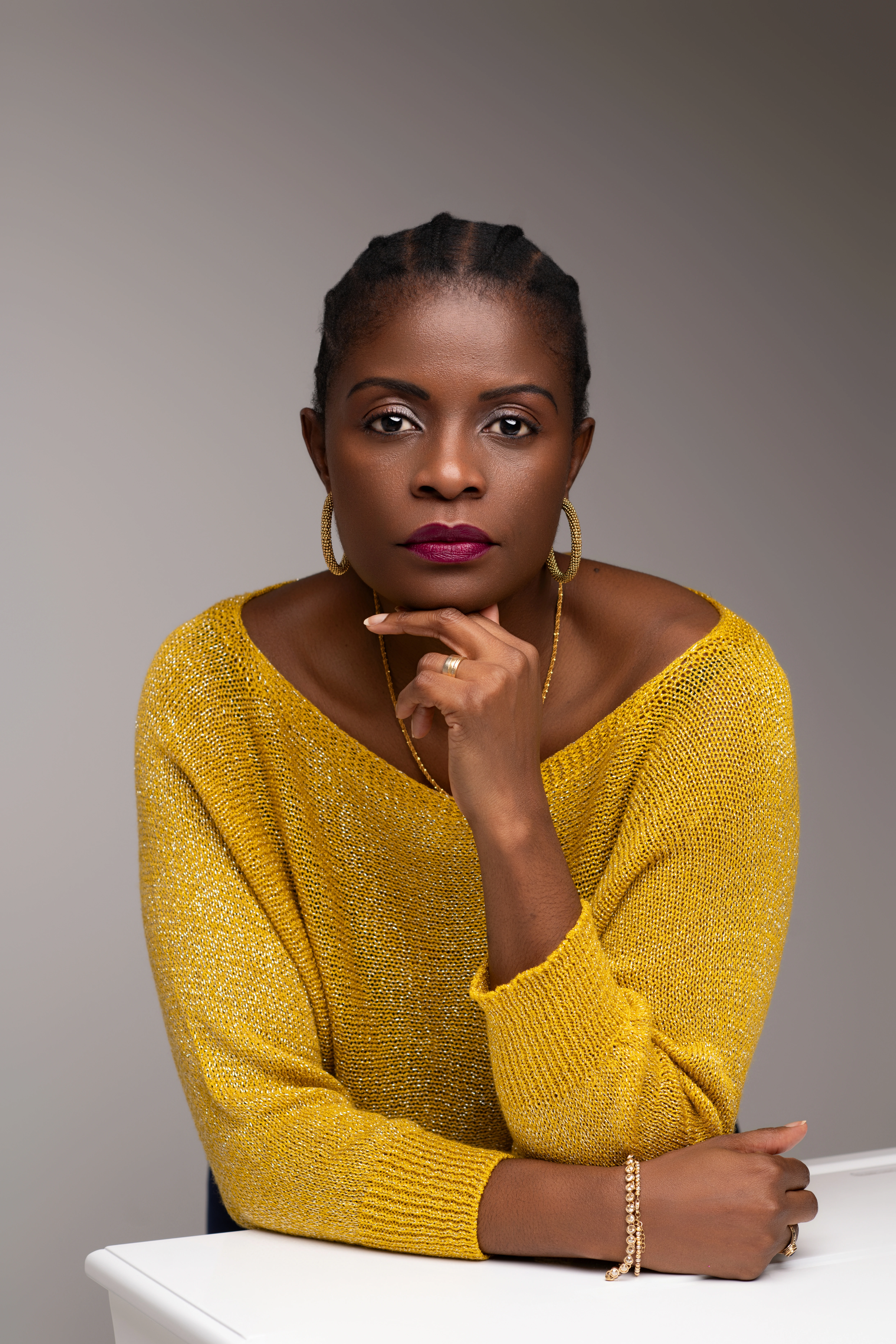 Jónia Presado corporate shoot — golden sweater pensive